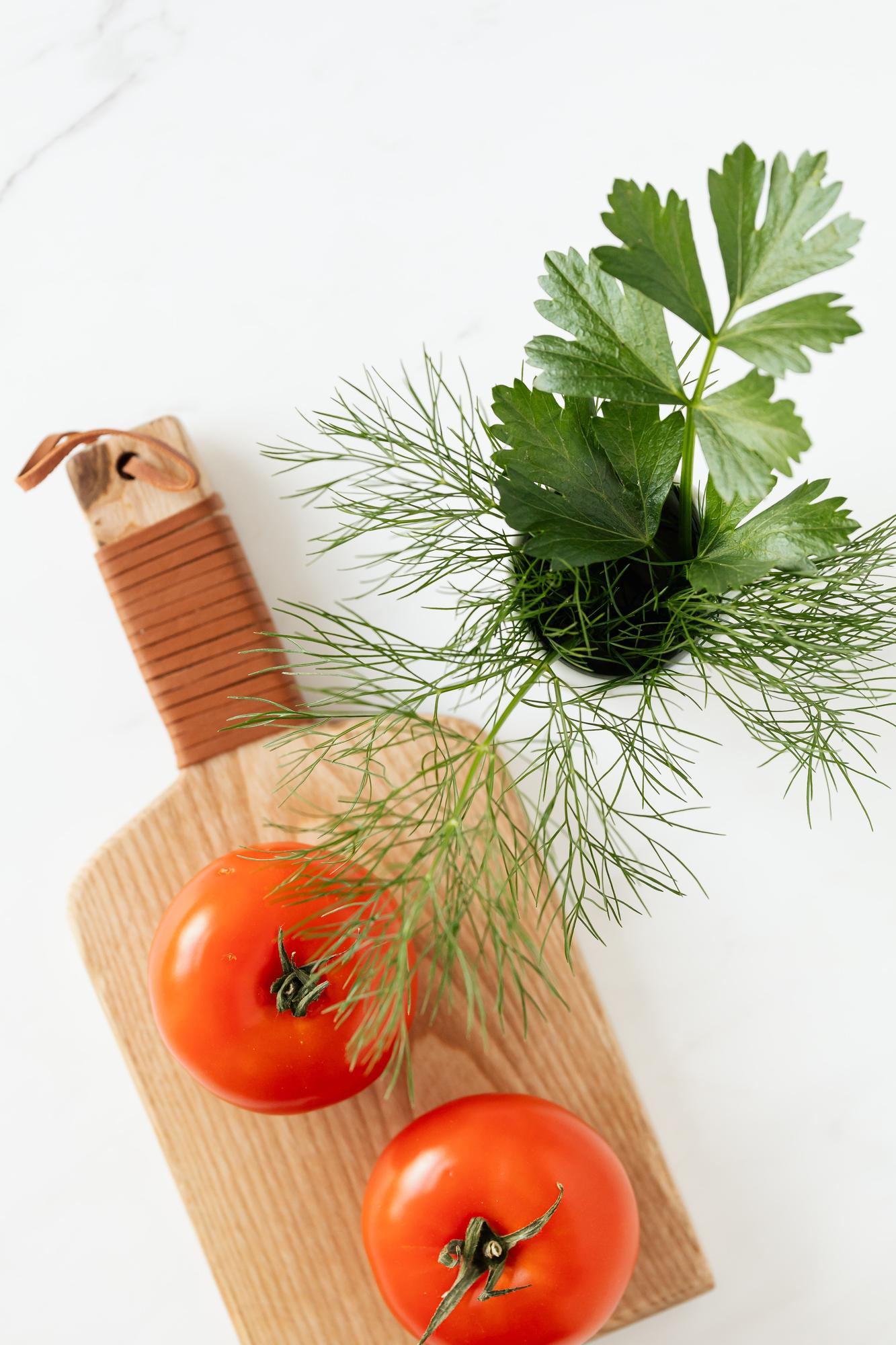 Close-up of seasonal vegetables and herbs on a kitchen counter